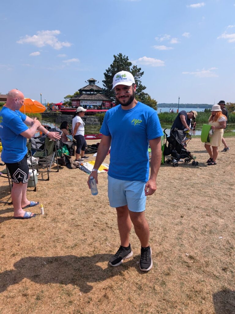 Picture of a male, smiling, dressed in a blue New Path United Dragons t-shirt and white hat.