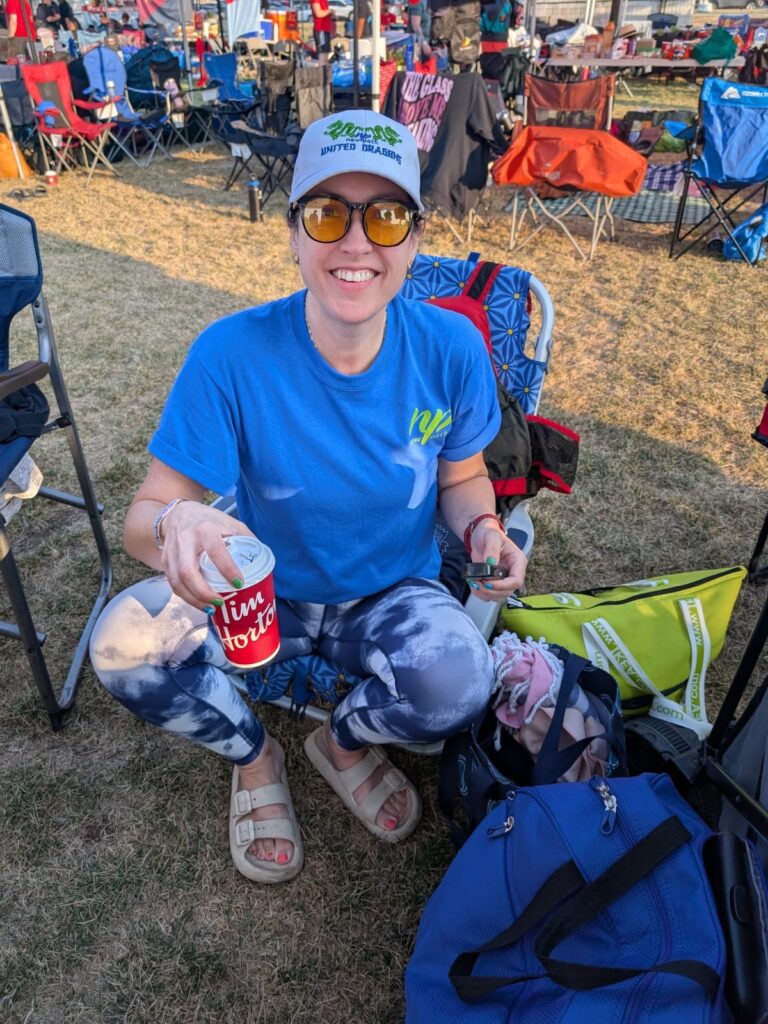 Picture of a female, smiling, dressed in a blue New Path United Dragons t-shirt and white hat.