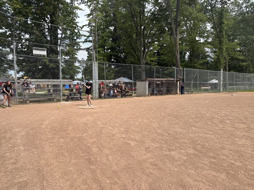 A person getting ready to bat in a baseball diamond. 