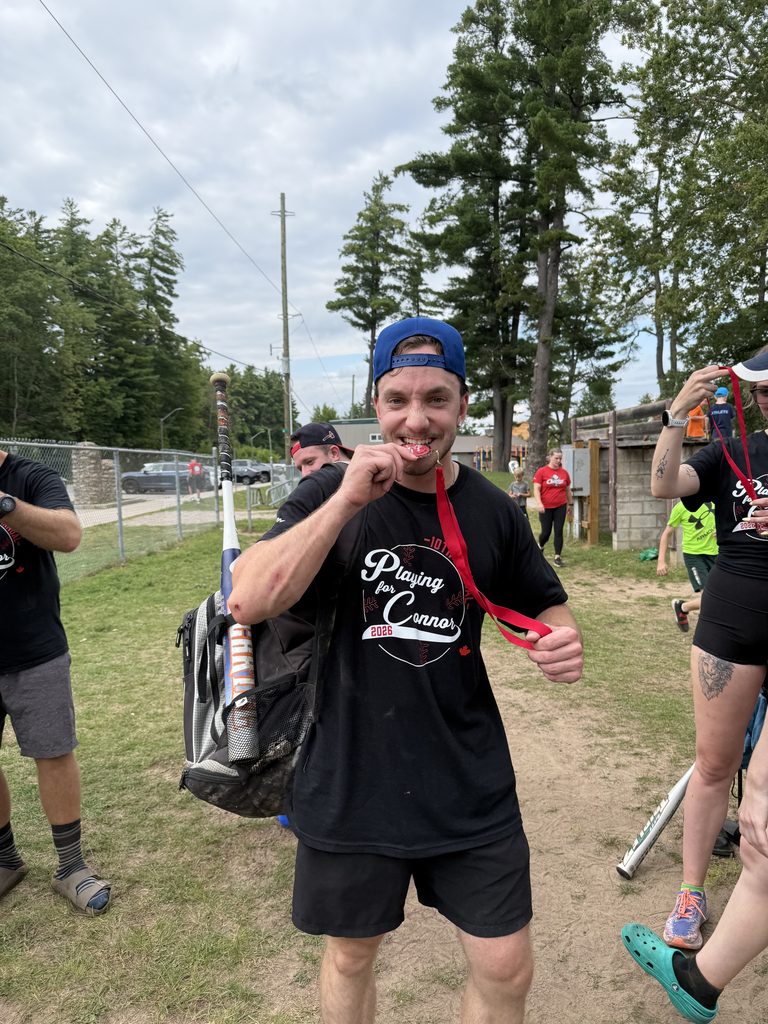 A man biting a medal
