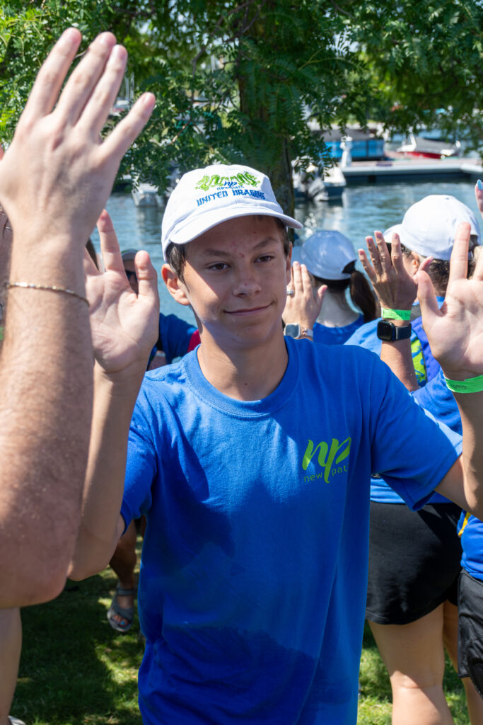 Picture of a boy giving high fives to other people