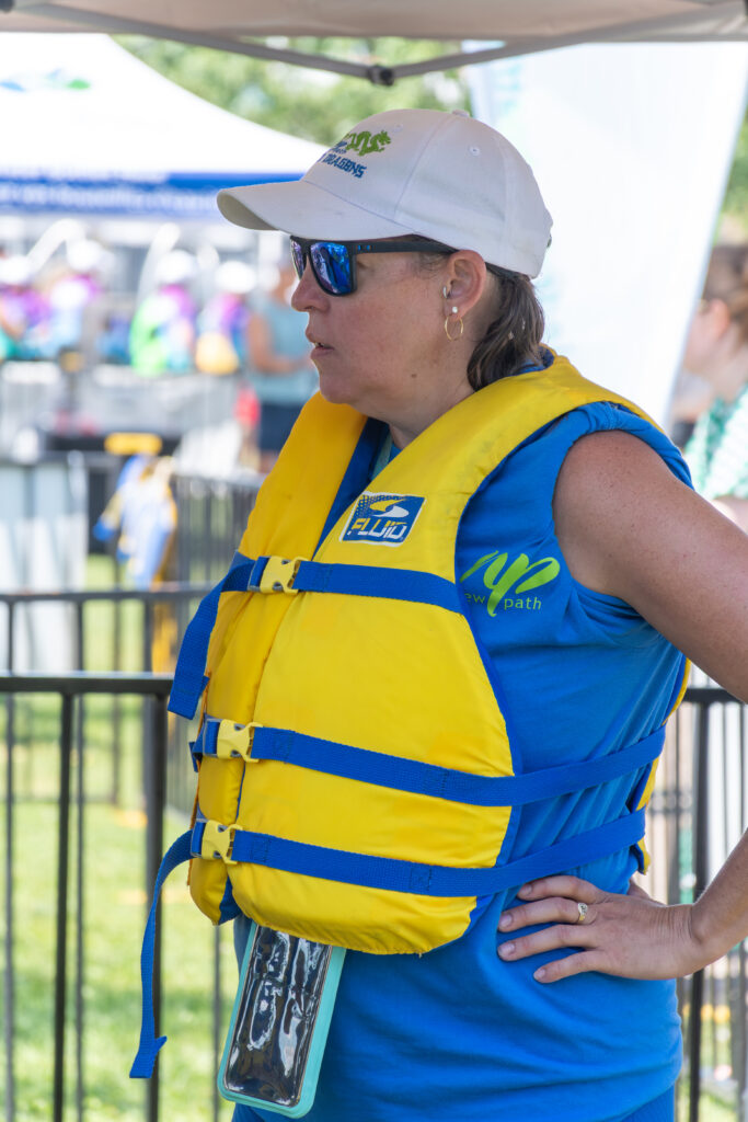 Picture of a woman wearing a life jacket and sunglasses