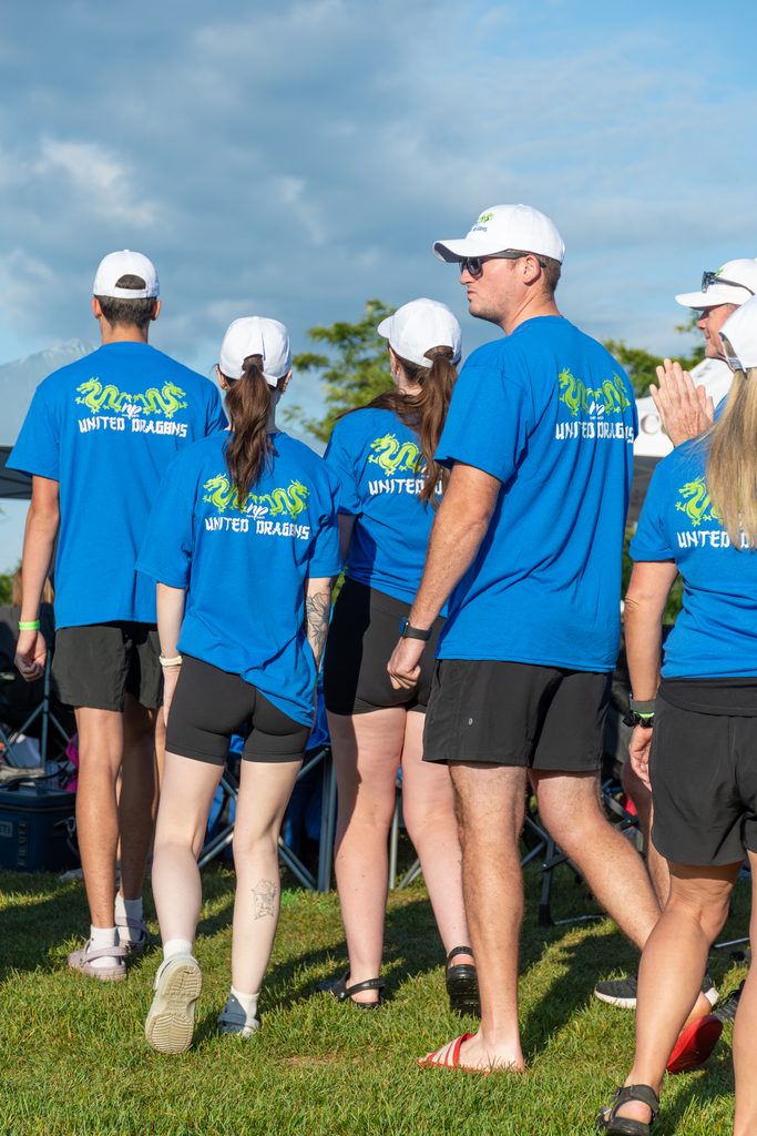 Picture of the back of a group of people wearing New Path United Dragons t-shirts