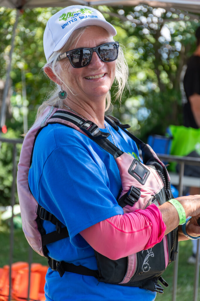 Picture of a woman wearing a life jacket and sunglasses