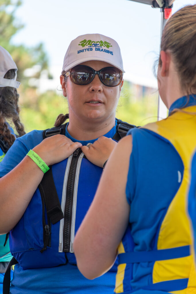 Picture of a woman wearing a life jacket and sunglasses