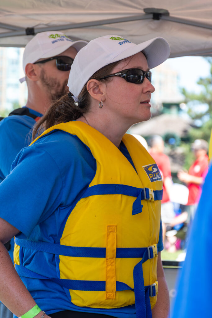 Picture of a woman wearing a life jacket and sunglasses