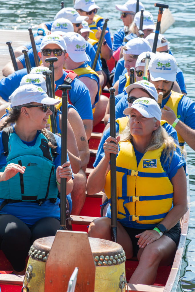 People on a dragon boat smiling