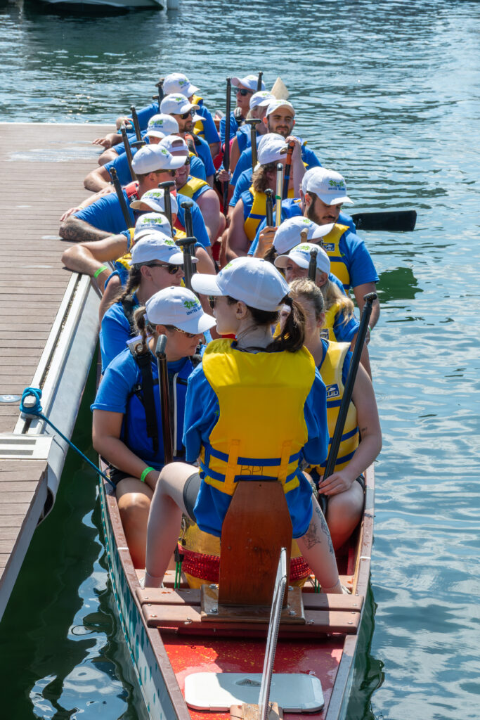 People leaving a dragon boat.