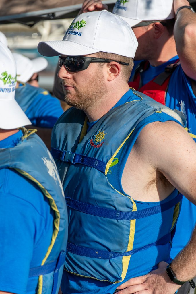 Picture of a person wearing a life jacket and sunglasses
