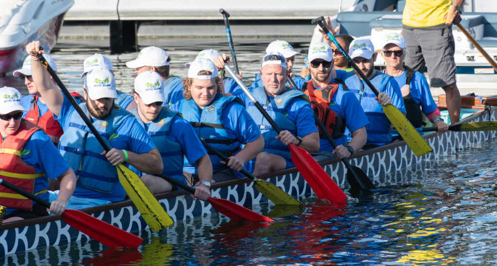 A dragon boat team paddling
