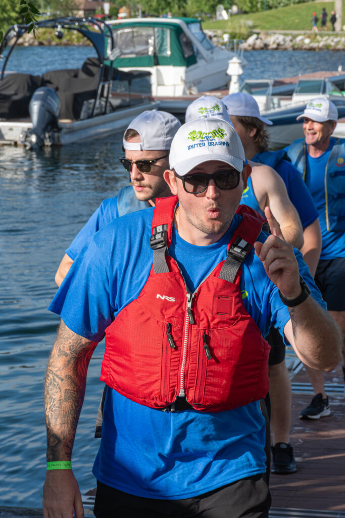 Picture of a group of people getting out of a dragon boat