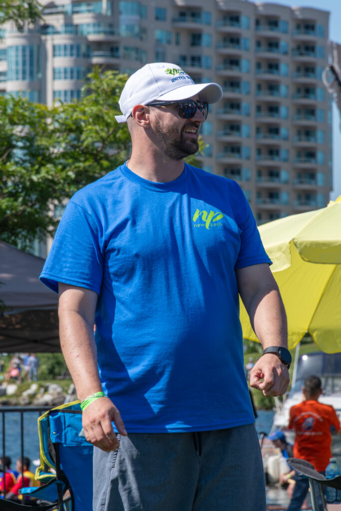 Picture of a man wearing a New Path United Dragon hat and t-shirt smiling