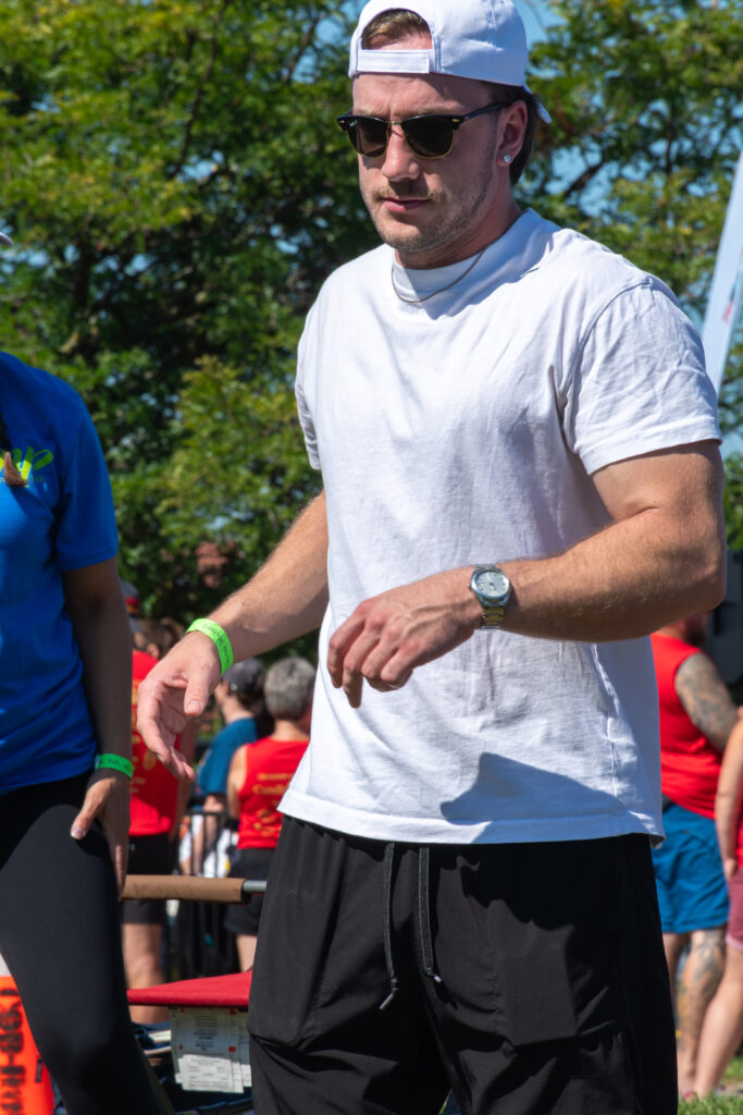 Picture of a man wearing a New Path United Dragon hat and t-shirt running