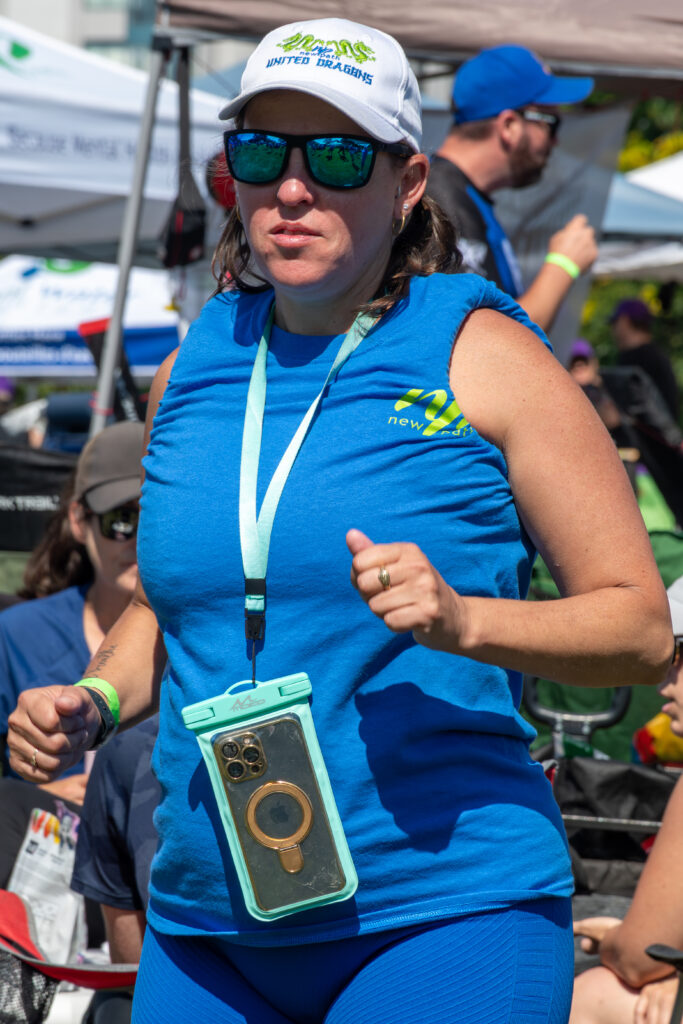 Picture of a woman wearing a New Path United Dragon hat and t-shirt running