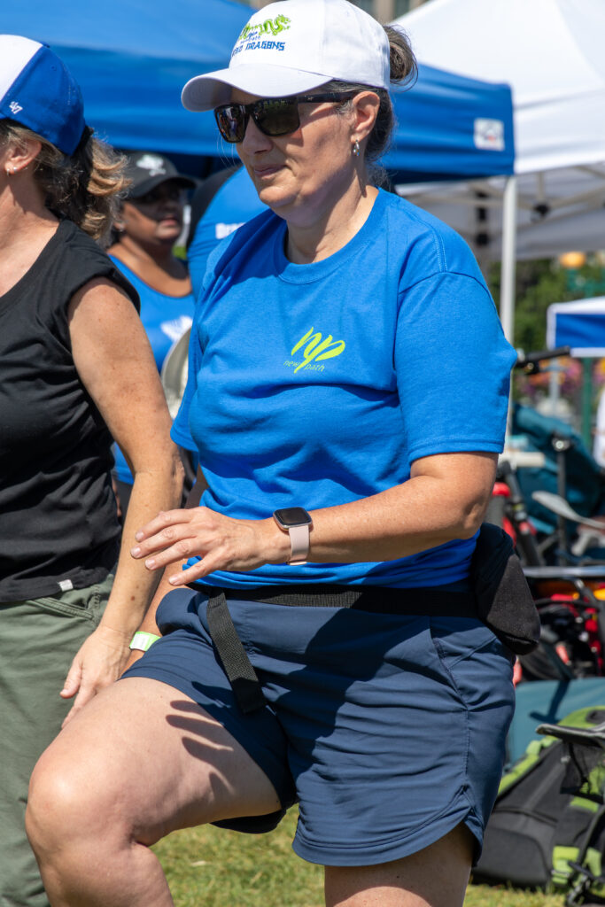 Picture of a man wearing a New Path United Dragon hat and t-shirt exercising