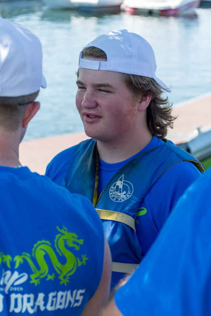 Picture of a man wearing a New Path United Dragon hat and t-shirt smiling