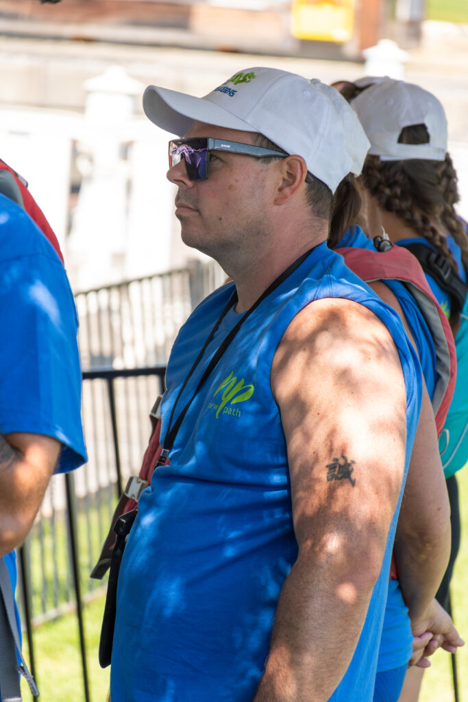Picture of a man wearing a New Path United Dragon hat and t-shirt looking serious