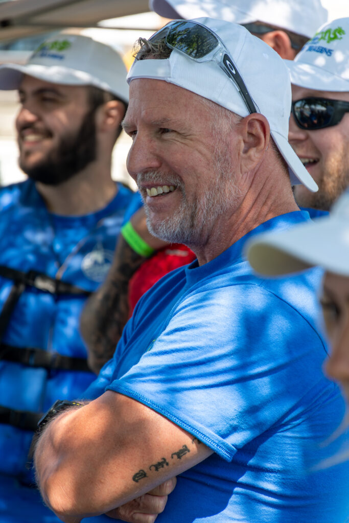 Picture of a man wearing a New Path United Dragon hat and t-shirt smiling
