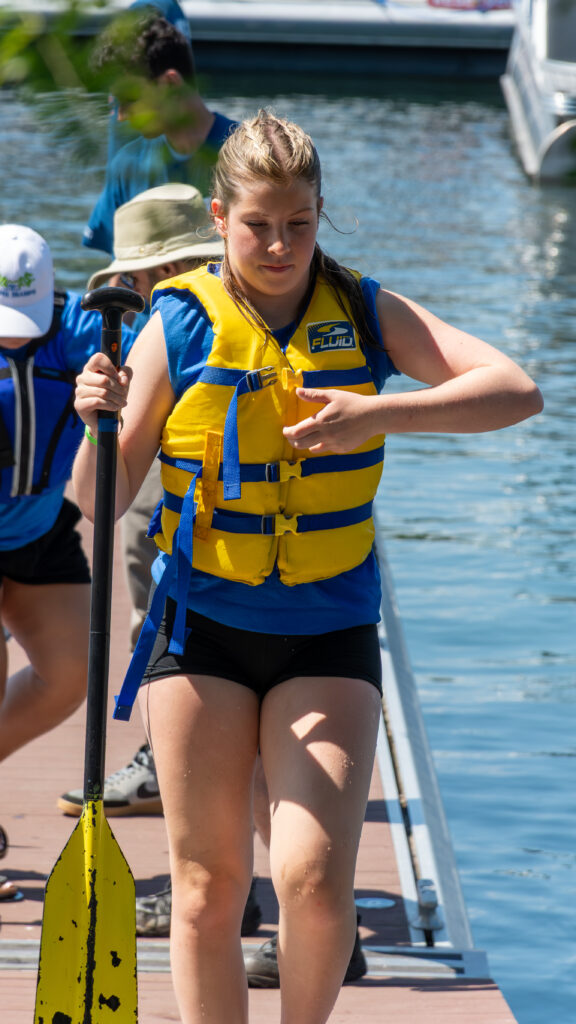 Picture of a woman taking off her life jacket